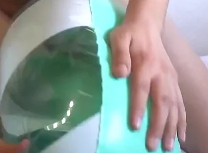 Playing with a Green and White Swimring