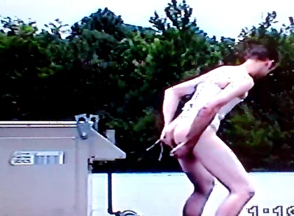 Crossdresser Riding a Giant Dildo on a Roof Top