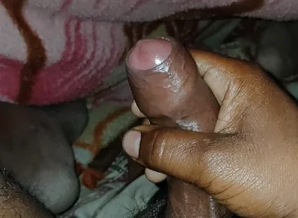 Big Boss massaging penis oil under the blanket