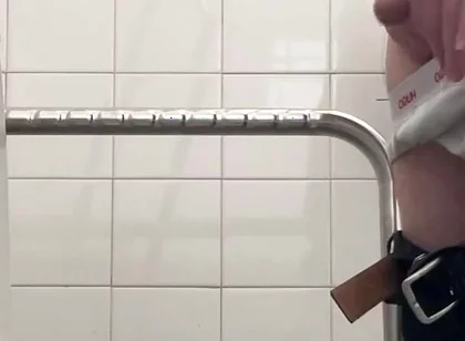 In the Hospital Toilets, a Guy Pisses Into a Cup for a Urine Sample, Then Gets Horny, Jerks-off and Cums