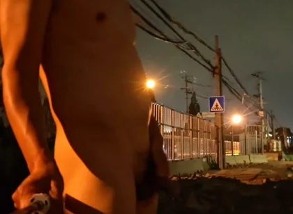 Naked by the Roadside with Lots of Motorcycles and Buses