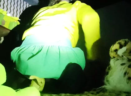 A Young Woman in a Skirt Spreads Her Buttocks Wide.