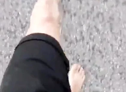 Jon Arteen Walks Barefoot on the Street Outdoors, the Boy Is Barefoot in the Crowded Tram to the Town Center